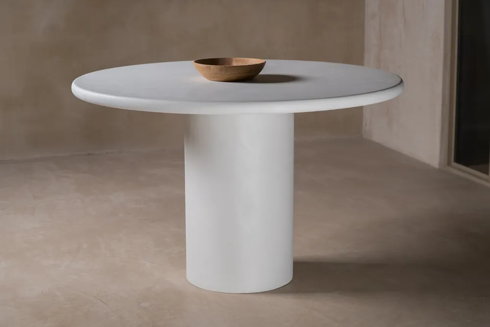 Round dining table with a chalk mineral finish